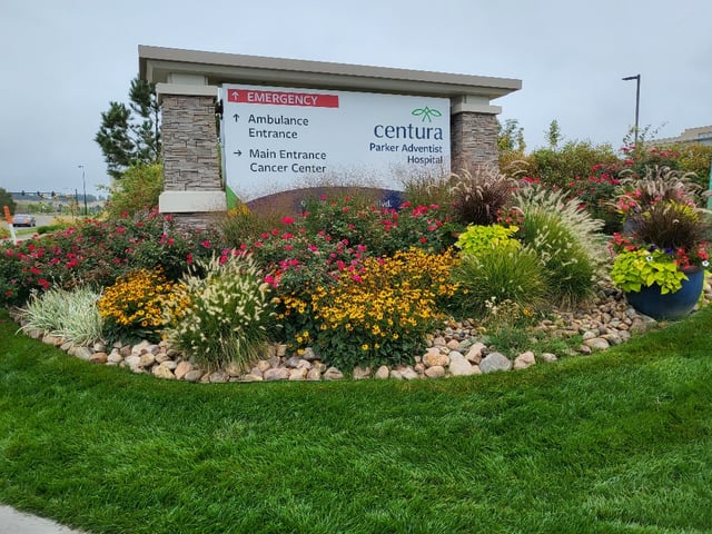 Centura Parker Adventist Hospital ground-level monument sign with directional wayfinding and landscaped garden