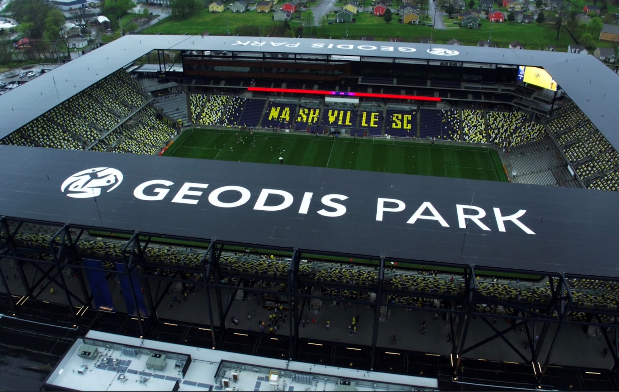 Aerial view of GEODIS Park with large white GEODIS PARK letters along the stadium roof edge